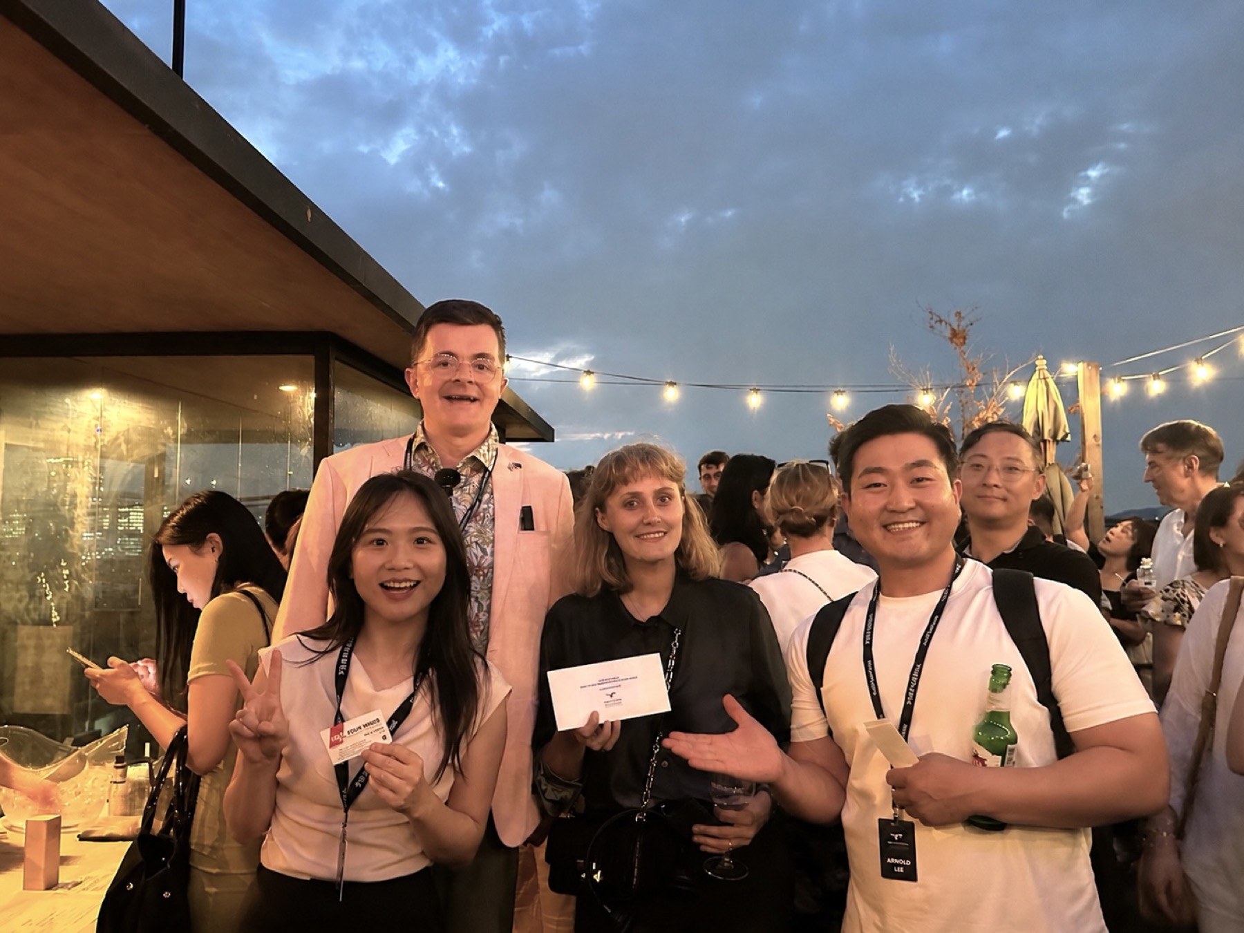 Guests at a rooftop networking evening, including Secretariat Director Arnold Lee